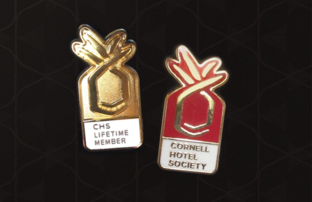 Cornell Hotel Society lapel pins with new brand identity. 