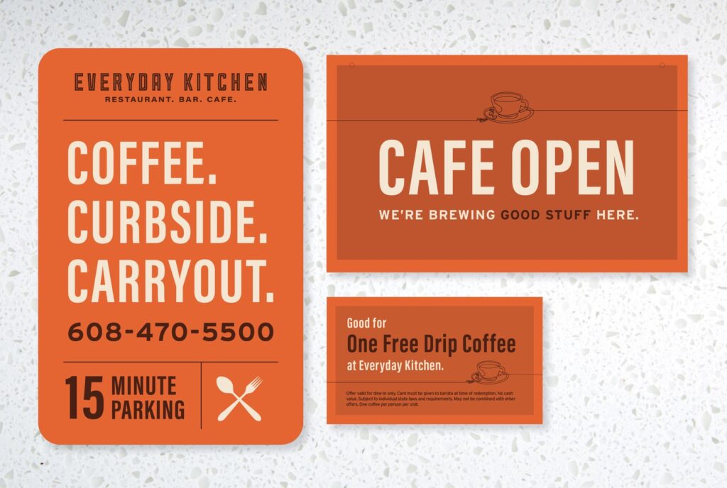 Everyday Kitchen Cafe environmental marketing signage and print materials on stone background. 