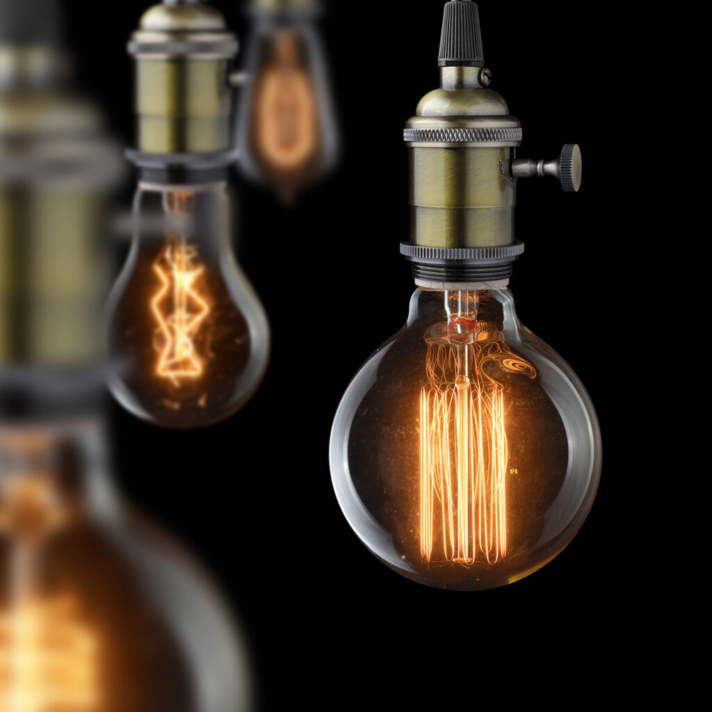 Cornell Hotel Society Brand Perception — Edison style light bulbs dimly lit.