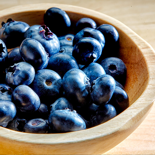 Everyday Kitchen Brand Positioning — up close image of blueberries in a wooden bowl. 